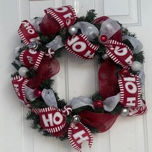 Handmade Christmas wreath, ribbon,bells, and ornaments. Silver, white and red